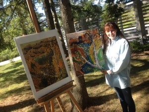 Joanie beside her rendition of Frank Carmichael's painting 