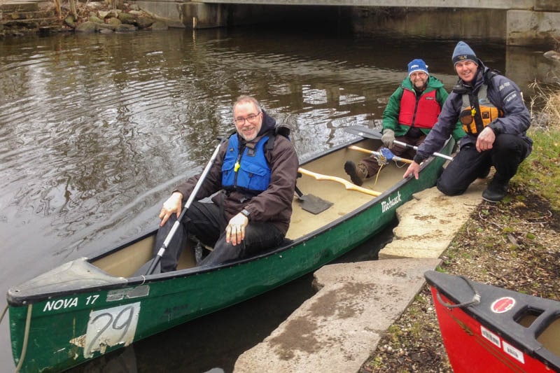Patrick McLean(bow) and Richard Wells(stern) accompany the McGuffins on a paddle up the Kalamazoo River as part of their visit to the College.